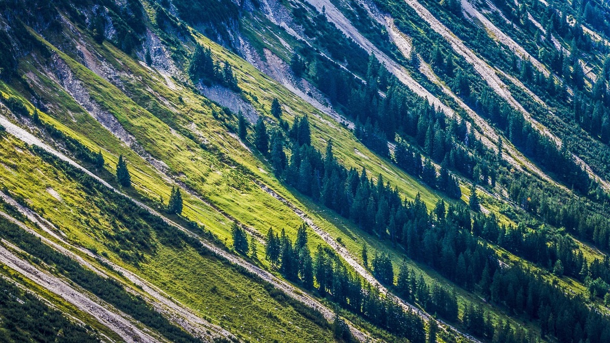 Hiker navigating steep slope with technical challenge