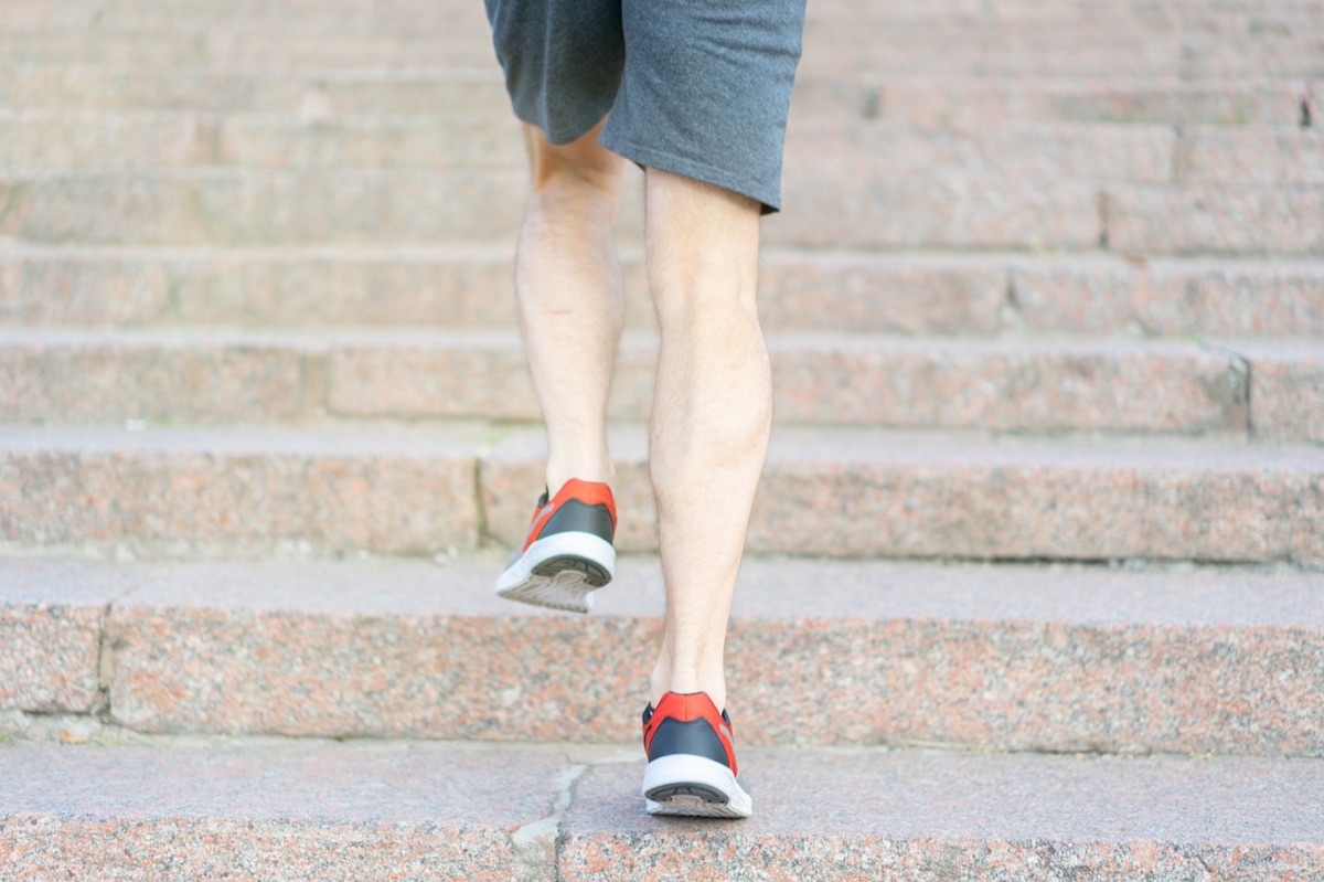 Runner ascending stair steps in mountain race